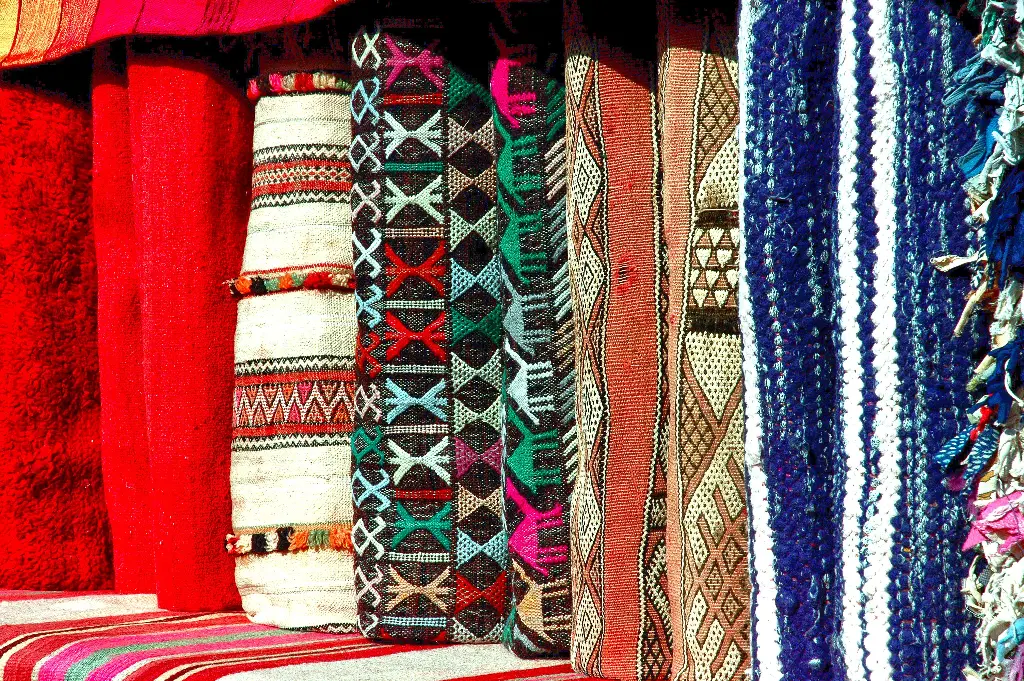 Colorful patterned fabric rolls in a row Image depicting fabric.
