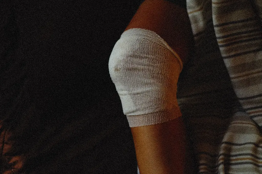Knee with bandage, showing an owie. Image depicting owie.
