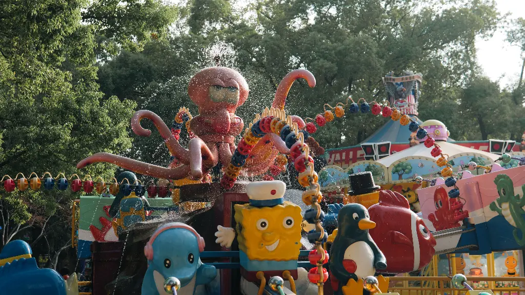 Colorful amusement park ride with cartoon characters and octopus. Image depicting park.