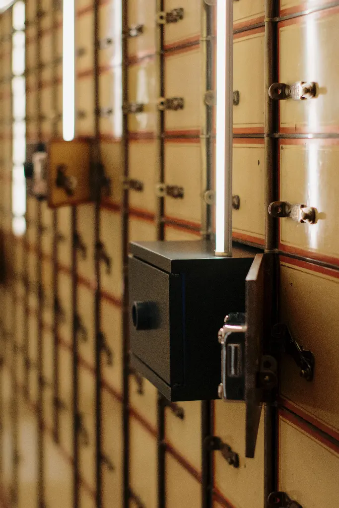 Rows of secure vault boxes in a bank. Image depicting vault.